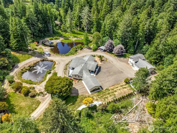Bird's-eye view showcasing the home's thoughtful design, expansive grounds, and private setting. Bird's-eye view showcasing the home's thoughtful design, expansive grounds, and private setting.