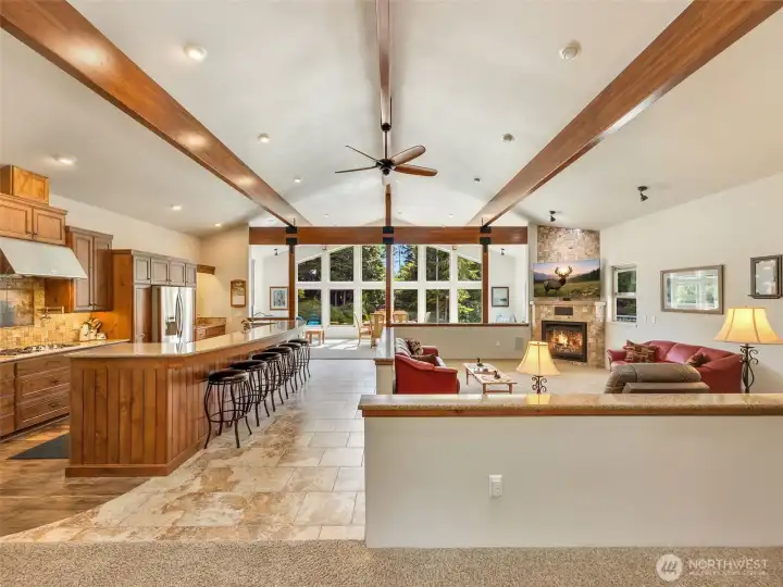 Vaulted ceilings, exposed timber beams, and walls of windows create an unforgettable great room. Vaulted ceilings, exposed timber beams, and walls of windows create an unforgettable great room.
