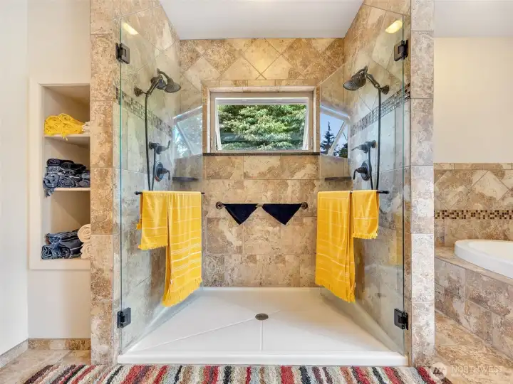 Expansive, dual head, tile shower creating a spa-like experience in the primary bath. Expansive, dual head, tile shower creating a spa-like experience in the primary bath.