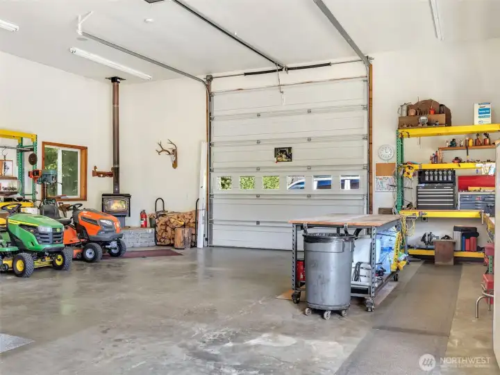Oversized garage with generous workspace and room for all your toys. The shop also includes a wood stove. Oversized garage with generous workspace and room for all your toys. The shop also includes a wood stove.