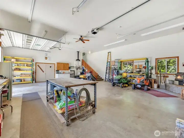 Oversized garage with generous workspace and room for all your toys. The shop also includes a wood stove. Oversized garage with generous workspace and room for all your toys. The shop also includes a wood stove.