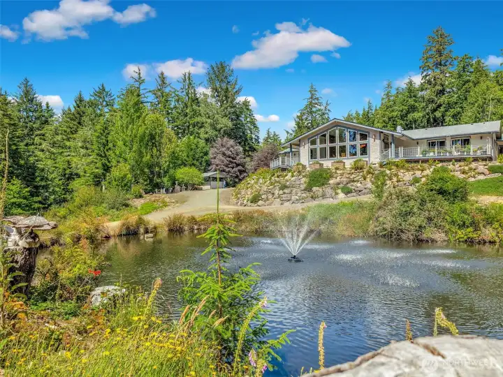 Beautiful water feature and manicured landscaping create a private backyard retreat. Beautiful water feature and manicured landscaping create a private backyard retreat.
