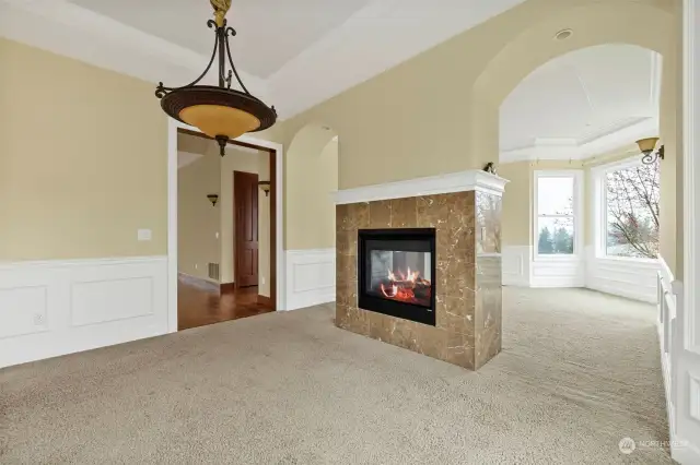 On the other side of the fireplace, is a light and bright room that could be used for another sitting/living room, 2nd office, or bonus area.