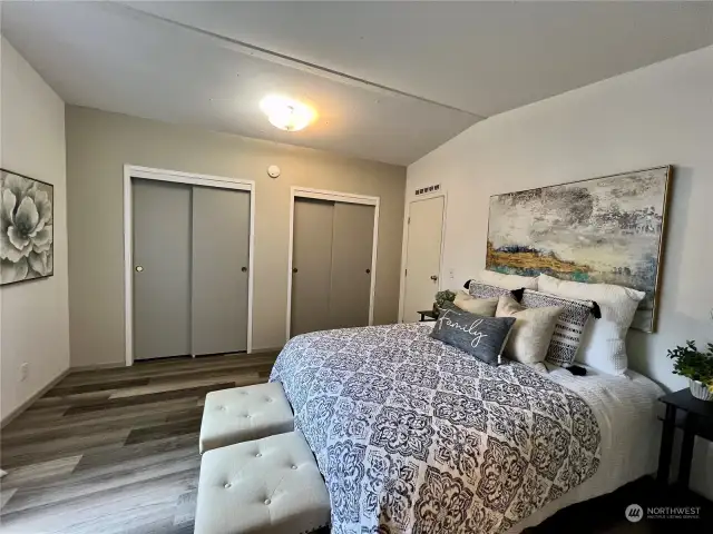 Double closets in primary bedroom w/ new flooring and paint.