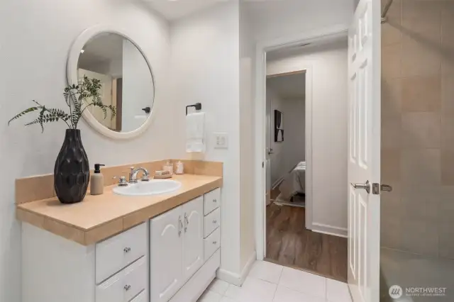 Spacious main floor full bath with tiled shower and tub on the main floor.
