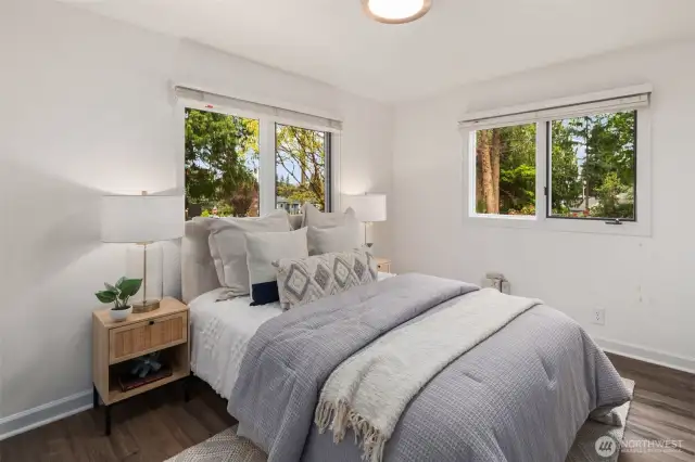 The third bedroom is bright and inviting, with two windows bringing in plenty of natural light. Soft neutral tones and warm lighting create a comfortable retreat.