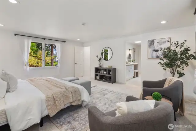 This bedroom is so spacious, with plush carpeting and soft, neutral tones creating a relaxing atmosphere. The ensuite bath is just steps away, offering convenience and privacy. Large windows on opposite walls offer a nice cross breeze in the summer.