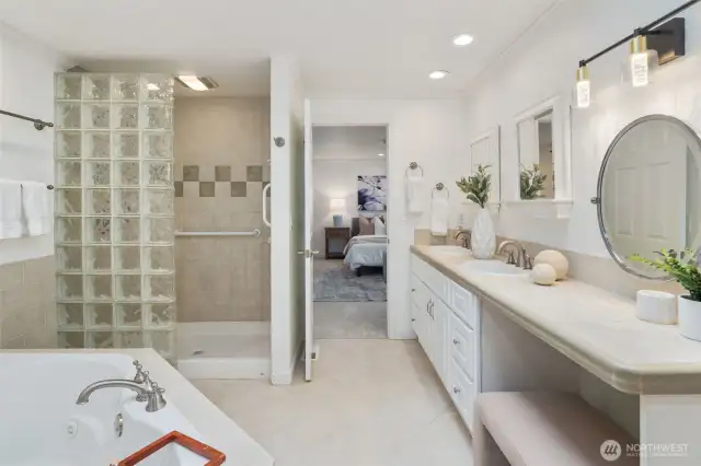 Bright and inviting, the walk-in shower features a stylish glass block partition, allowing natural light to filter through. A skylight above enhances the airy feel of this well-designed space.