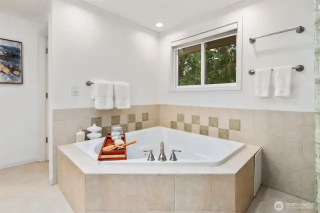 Unwind in the comfort of this comfy jetted tub, surrounded by soft lighting and elegant tilework—perfect for a relaxing soak at the end of the day.