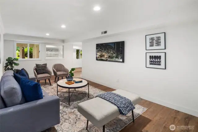 This inviting basement bedroom offers warmth and comfort with a cozy gas fireplace as its centerpiece. Thoughtful recessed lighting and light walls keep the space feeling bright and open, while rich wood flooring adds warmth.