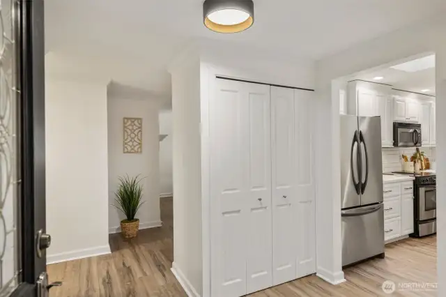 The spacious foyer offers a warm welcome while maintaining privacy for the living areas. A large coat closet keeps essentials organized, and the open layout provides an easy flow to the kitchen and living room for effortless entertaining.