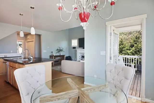 Looking back from the dining area. Open door leads to your covered balcony. In the distance, the closet across from the stairwell includes the washer & dryerh. The hall just before the closet leads to your main level 1/2 bath.