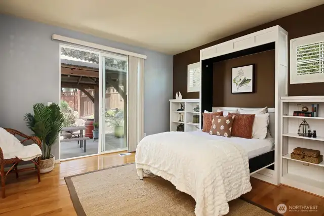 This is considered the Primary Bedroom with walk-in-closet & full bath, however, sellers have made this a second living room with a Murphy Bed (conveys), and have preferred to make the upper level their Primary Suite. Let's step outside for a quick peek of your backyard oasis.