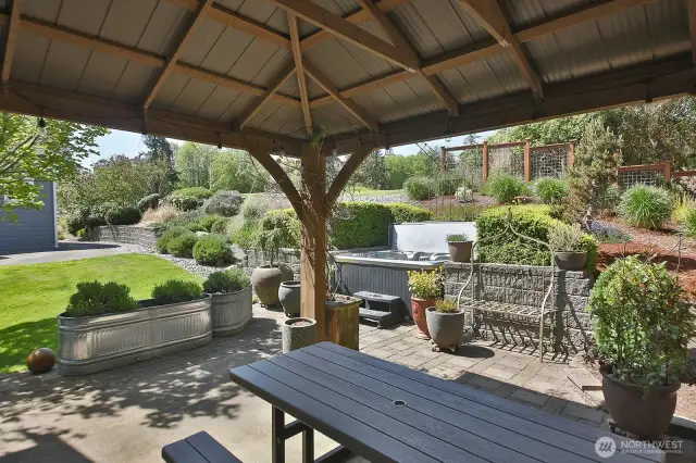 Gazebo creates a generous covered area on your back patio. Mature/established landscaping with a hot tub tucked into your terraced gardens provides a true backyard that you will enjoy year round. Hot tub & picnic table convey.