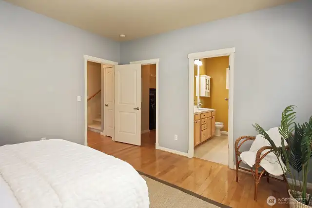 Spacious walk in closet (open door to the left of the bathroom) with a safe that can convey (or be removed). Just outside the Primary bedroom you see the staircase to the upper level. The linen closet is just before the staircase and the washer and dryer are across from the stairwell.
