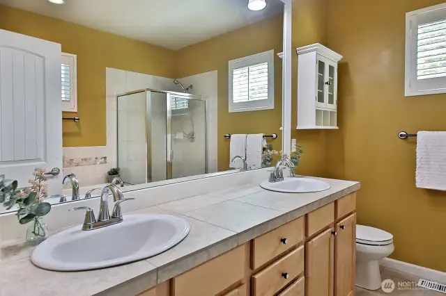 Primary Bathiled has tiled flooring, counter and shower.