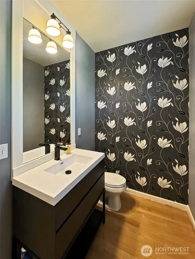 Main level updated half bath. Maple floors. There is a window on the wall at the right edge of this photo.  Let's head upstairs......