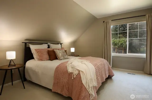 Up the stairs and to the left is your second bedroom. Sellers have made the upper level their Primary Suite. The floor plan in this home allows for all kinds of possibilities. Windows look out upon that beautiful backyard of yours.