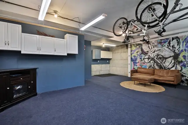 This garage lived as Seller's "man cave" and has a fun and vibrant vibe. Come bring your own ideas or shift it back to a traditional garage. There is a walk in storage closet on the other side of the wall straight ahead/to the left. Garage door (one of two) is at your back.