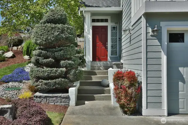 A colorful entry with the blooms and red door. Come on inside.....