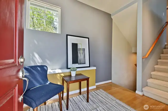 You have just entered the home. Down the stairs to the 2-car garage/rec space. Up the stairs to the main level. Maple floors at your feet and also on the main level. Let's go up.