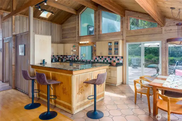 A tropical bar separates the dining area and kitchen with sliding door to the deck.