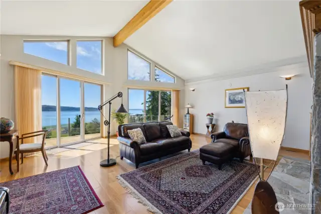 The main living area is open with vaulted ceilings, stone finished gas fireplace, Hardwood floors that are in beautiful condition and a wall of twin glass sliders that open to the expansive deck.