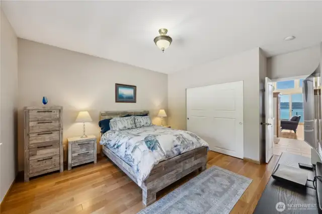 You can see the water view through the door of this lovely guest room.