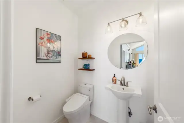 Bright, light clean Guest Bath on the main level. You can see the view reflected in the mirror.