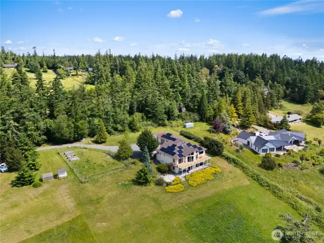 You have privacy, over 2 acres, a huge, fenced orchard with fruit trees and raised garden beds.  There is lots of parking, room for a large boat or RV.