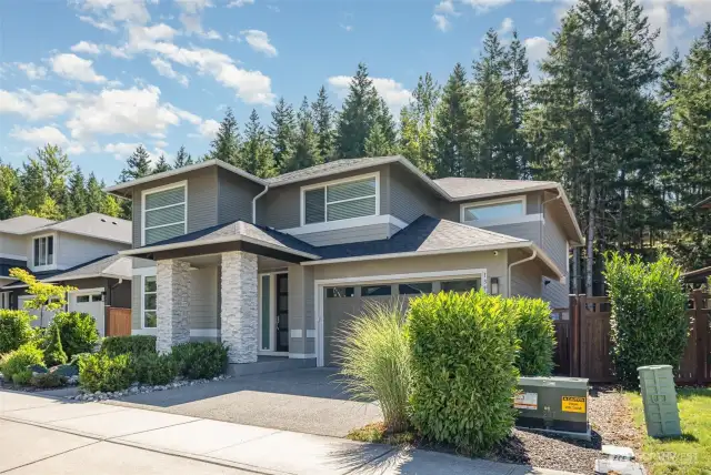 Great curb appeal enhanced by lush, established landscaping that offers beauty and privacy.