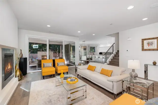 The living room remains subtly separated from the dining area and kitchen, creating a defined yet open-concept layout ideal for both relaxation and entertaining.