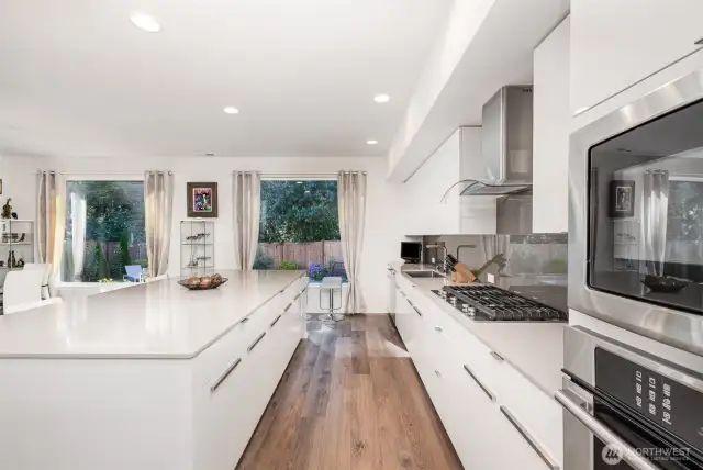 The supersized island provides abundant storage and counter space, along with ample seating—perfect for casual dining and effortless entertaining.