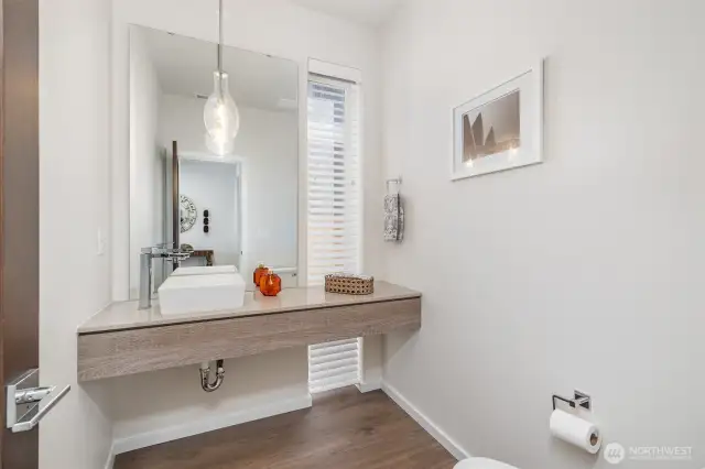 Stylish modern powder room on the main floor for guests’ convenience.