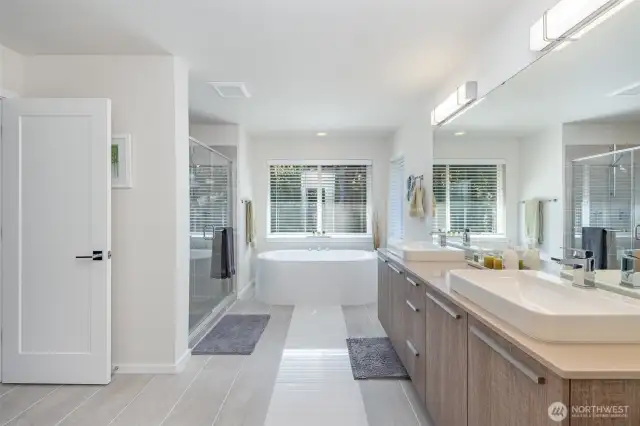Indulge in the luxurious primary en-suite, boasting dual vanities for effortless morning routines, a spacious shower & separate tub, and a private water closet for added convenience and privacy.