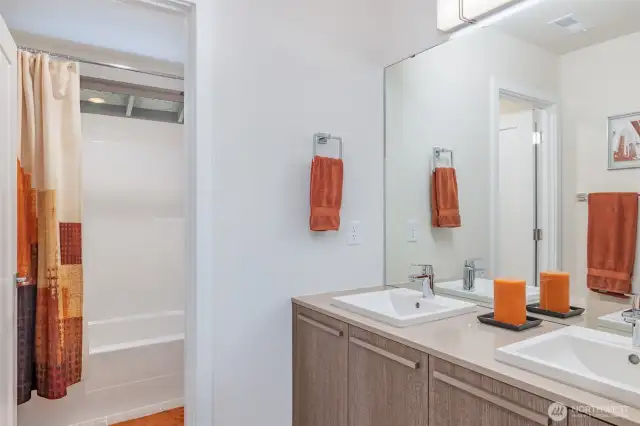 Upstairs full bathroom features dual vanities, generous storage, and a separate water closet for added privacy and convenience.