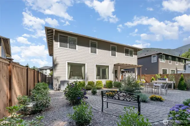 Backyard boasts established landscaping, creating a serene and private outdoor retreat.