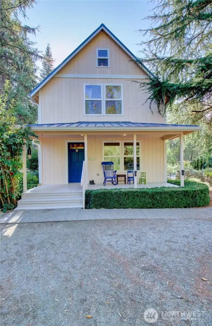 Two story home with covered front deck entrance.