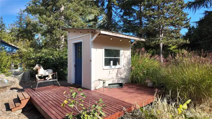 Garden shed with space for tools, or whatever you want the use to be. Large deck area to enjoy the garden.