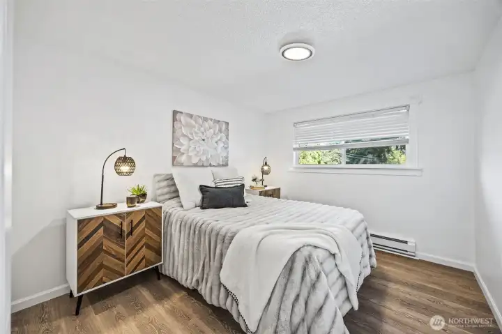 Bright primary bedroom filled with natural light.