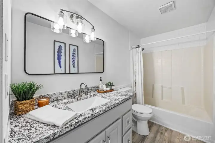 Renovated full bathroom conveniently located near the three main-floor bedrooms.