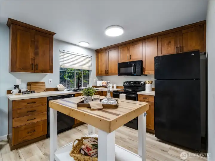 The dark cabinets in this kitchen make it a comfortable, friendly space to entertain