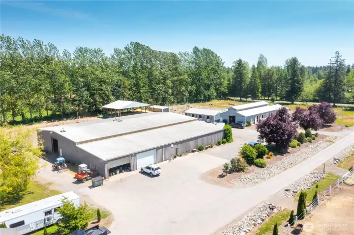 30+ stalls including several with runs, two barns, a 120' x 60' covered indoor arena, and a 250' x 175' outdoor arena, all fully fenced and cross-fenced.