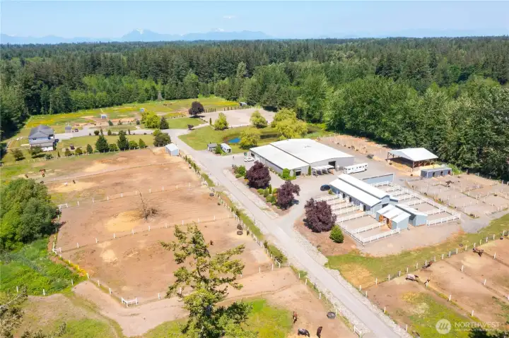 A paved driveway, ample parking, gated entry, and separate parcels for the home and barn add flexibility, privacy, and security.