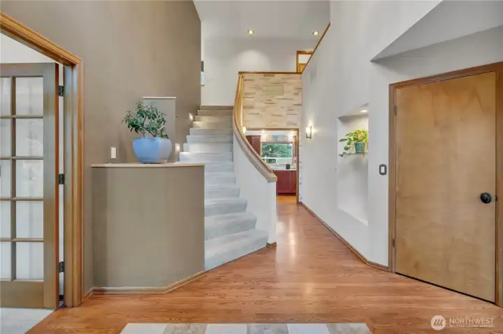 Grand entry hall with refinished hardwood flooring.