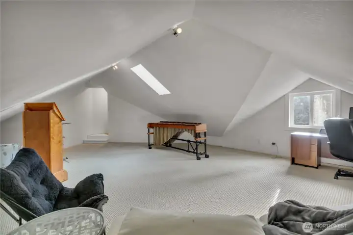 Bonus room accessed from primary closet or garage stairway