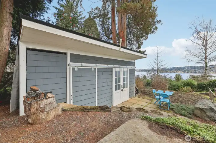 Large storage shed tucked away toward north property line