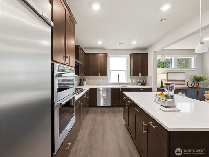 Another great view of the kitchen. Photo is representational. Actual home is under construction and finishes and paint colors may vary. See site agent for details....