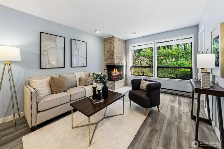 Living room has multiple configuration options, wood-burning fireplace & garden views.