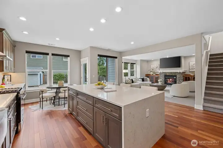 Open kitchen and breakfast nook flowing seamlessly into the great room, creating a light-filled space ideal for casual dining and gathering.